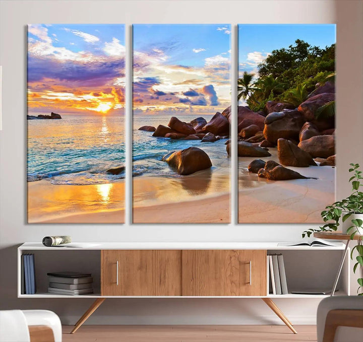 Tropical beach sunset canvas print featuring ocean waves and rocky shoreline. Coastal decor printed on giclee canvas with high-quality Canon print technology.