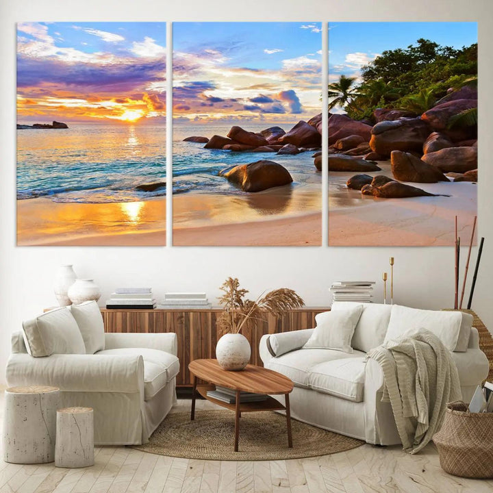 A captivating Tropical Beach Sunset Canvas Print, featuring ocean waves and a rocky shoreline, graces the wall.