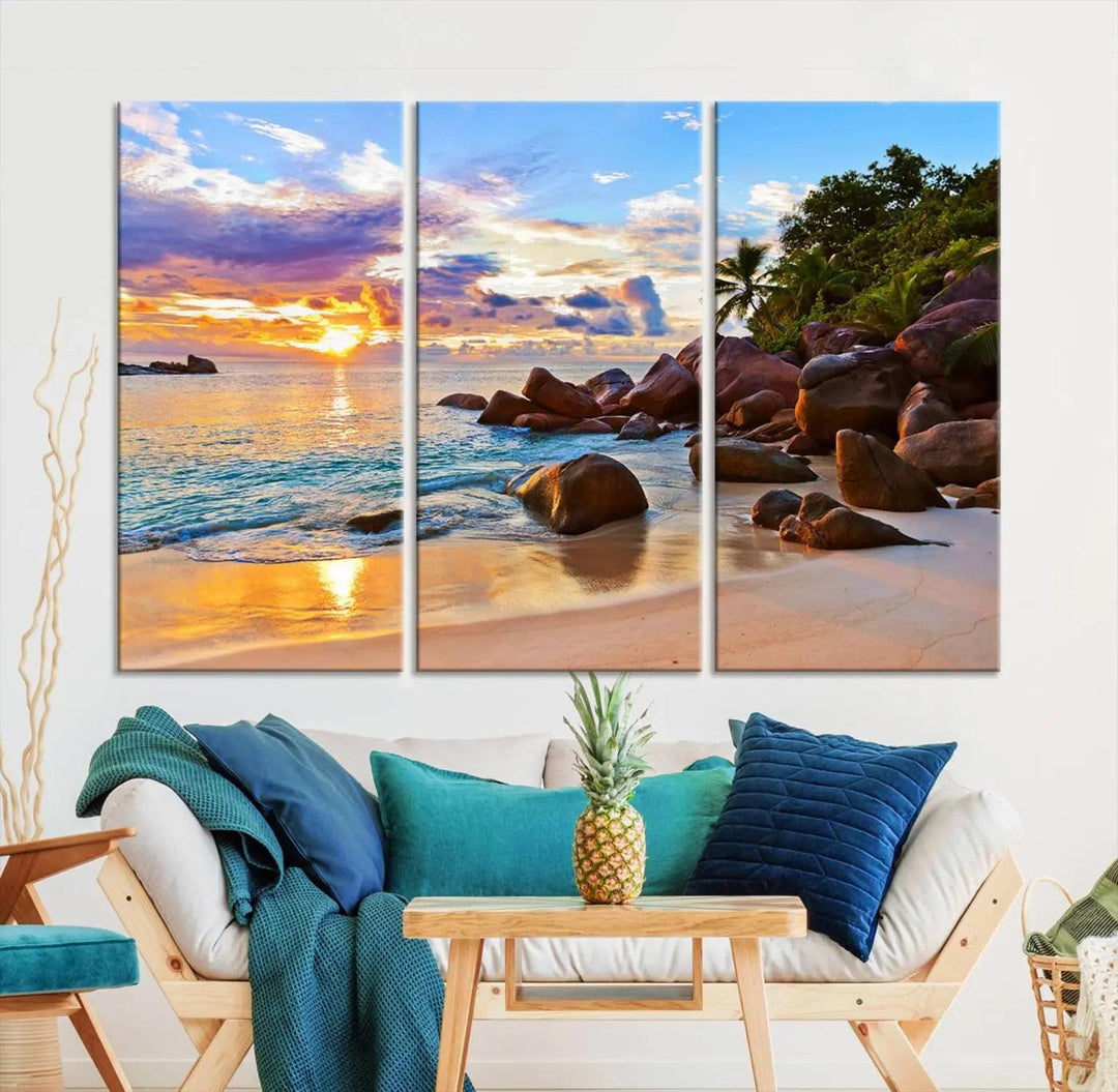 Tropical beach sunset canvas print featuring ocean waves and rocky shoreline. Coastal decor printed on giclee canvas with high-quality Canon print technology.