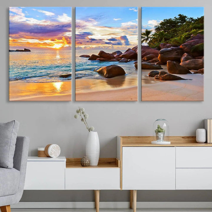 Tropical beach sunset canvas print featuring ocean waves and rocky shoreline. Coastal decor printed on giclee canvas with high-quality Canon print technology.