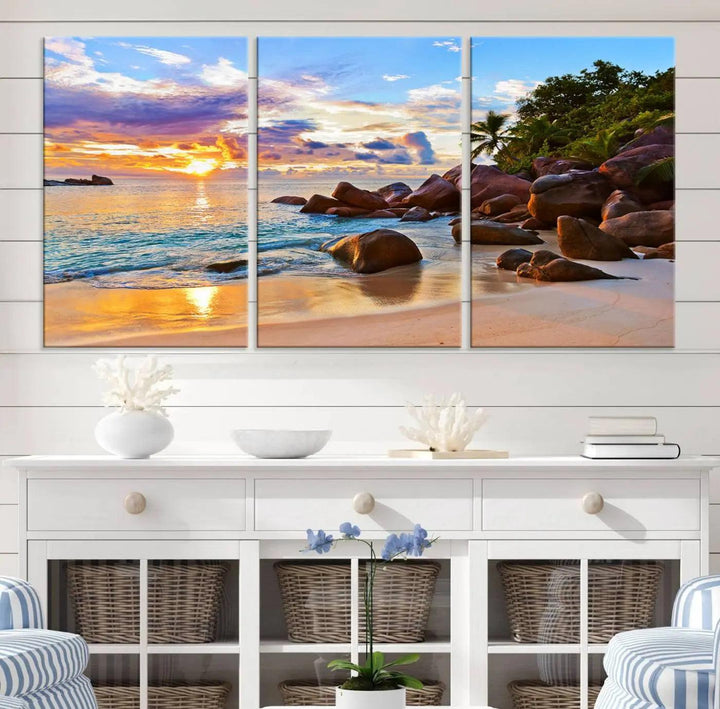 Tropical beach sunset canvas print featuring ocean waves and rocky shoreline. Coastal decor printed on giclee canvas with high-quality Canon print technology.