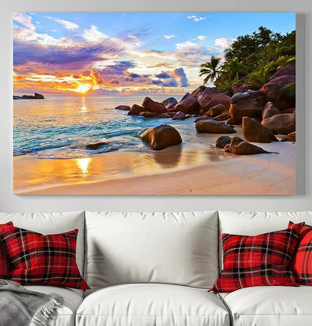 A captivating Tropical Beach Sunset Canvas Print, featuring ocean waves and a rocky shoreline, graces the wall.