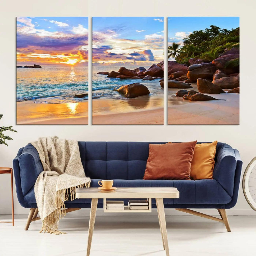 Tropical beach sunset canvas print featuring ocean waves and rocky shoreline. Coastal decor printed on giclee canvas with high-quality Canon print technology.