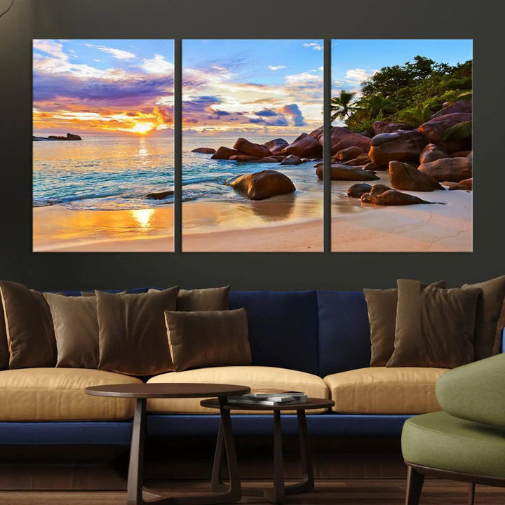 Tropical beach sunset canvas print featuring ocean waves and rocky shoreline. Coastal decor printed on giclee canvas with high-quality Canon print technology.