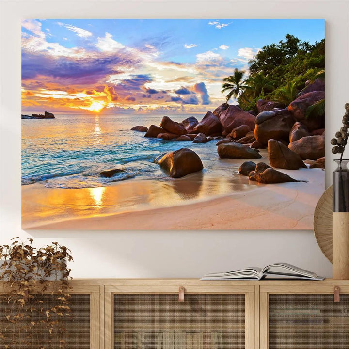 Tropical beach sunset canvas print featuring ocean waves and rocky shoreline. Coastal decor printed on giclee canvas with high-quality Canon print technology.