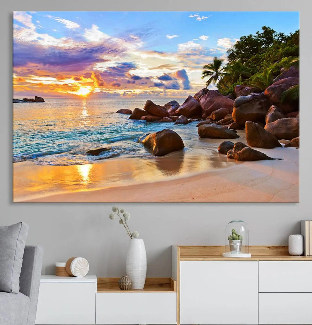 Tropical beach sunset canvas print featuring ocean waves and rocky shoreline. Coastal decor printed on giclee canvas with high-quality Canon print technology.