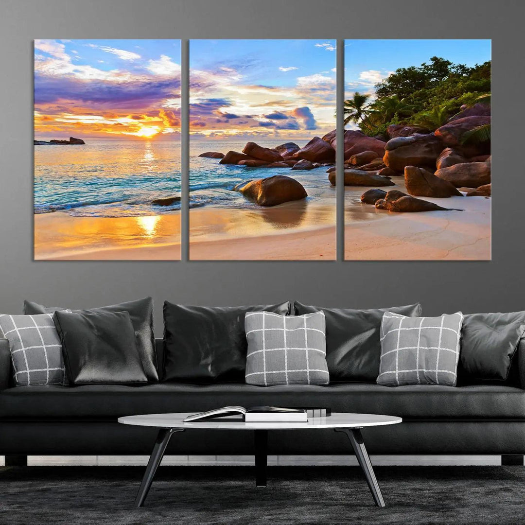 Tropical beach sunset canvas print featuring ocean waves and rocky shoreline. Coastal decor printed on giclee canvas with high-quality Canon print technology.