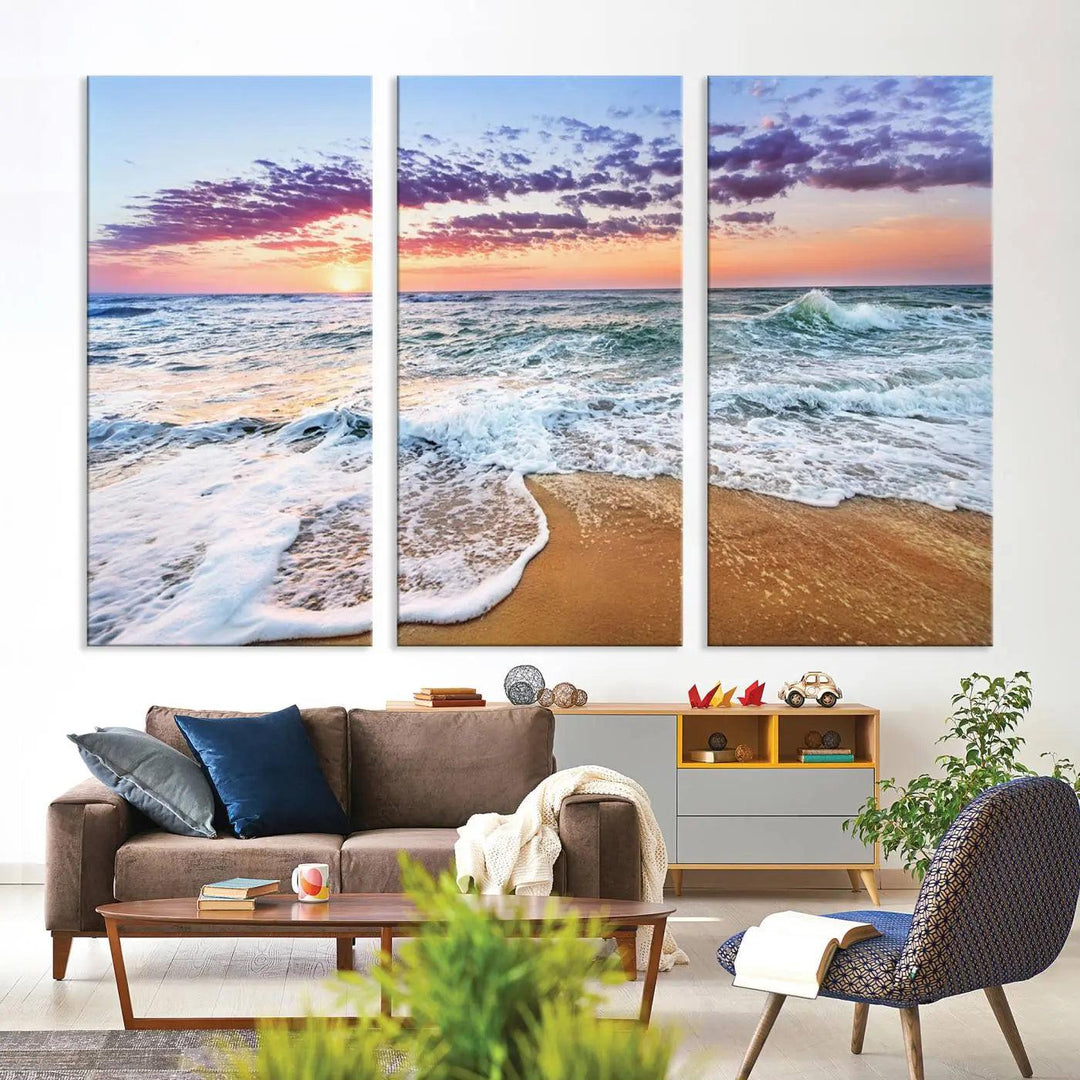 A triptych canvas wall art featuring the Tropical Beach Waves Art Print with a sunset ocean seascape adds striking beauty and perfectly complements the modern living room’s coastal decor.