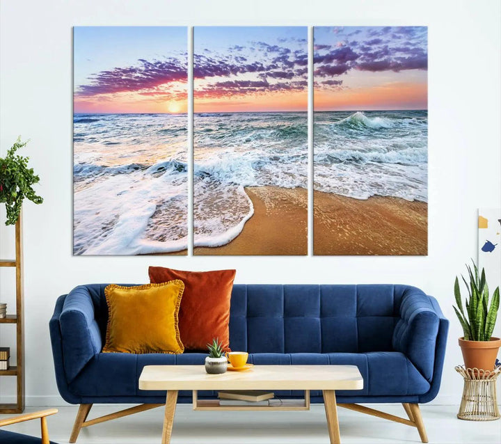 A triptych canvas wall art featuring the Tropical Beach Waves Art Print with a sunset ocean seascape adds striking beauty and perfectly complements the modern living room’s coastal decor.