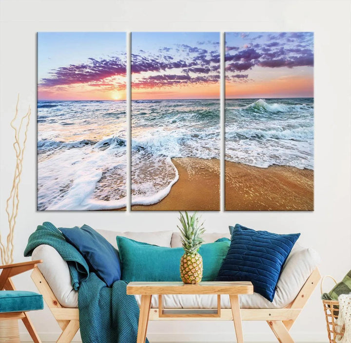 A triptych canvas wall art featuring the Tropical Beach Waves Art Print with a sunset ocean seascape adds striking beauty and perfectly complements the modern living room’s coastal decor.