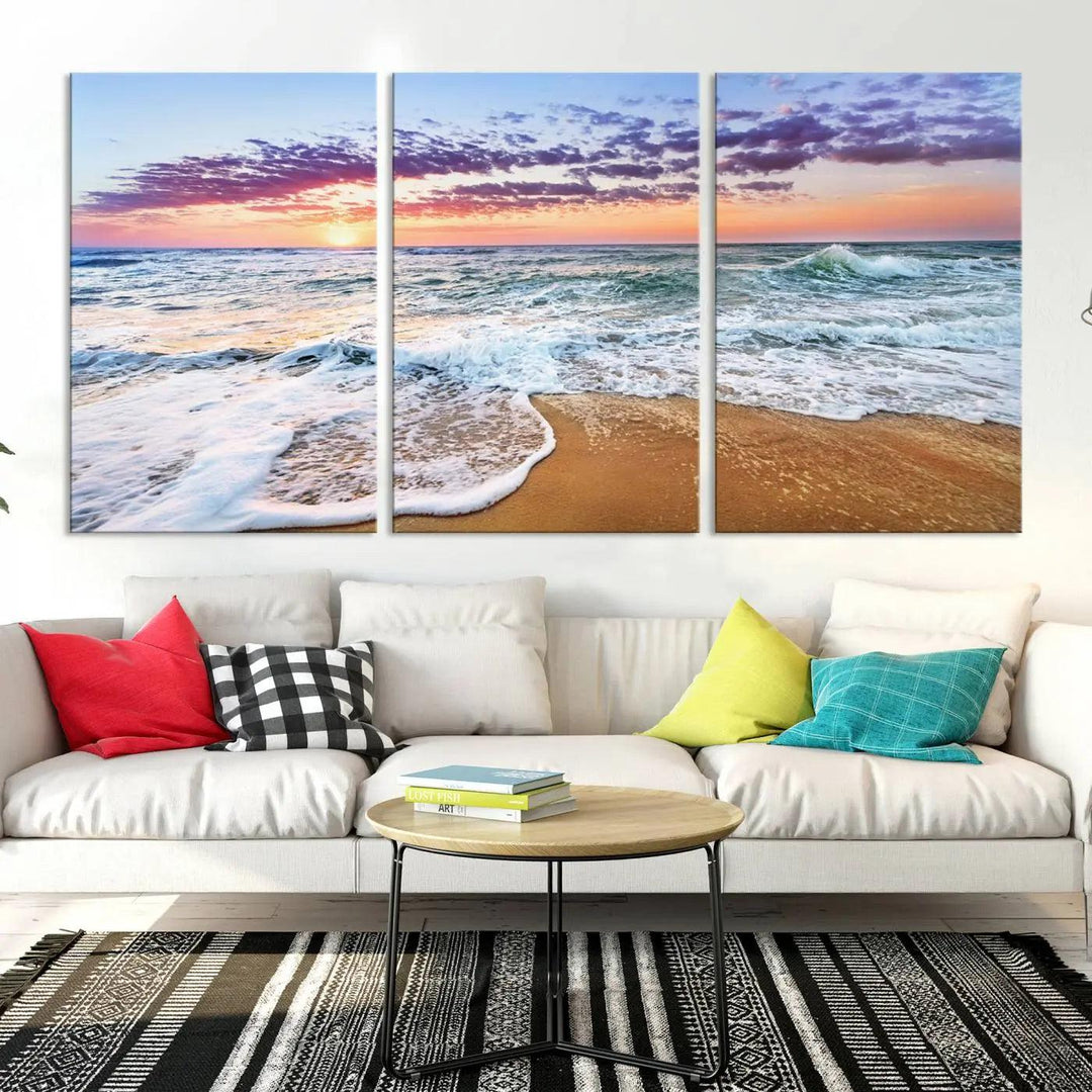 A triptych canvas wall art featuring the Tropical Beach Waves Art Print with a sunset ocean seascape adds striking beauty and perfectly complements the modern living room’s coastal decor.