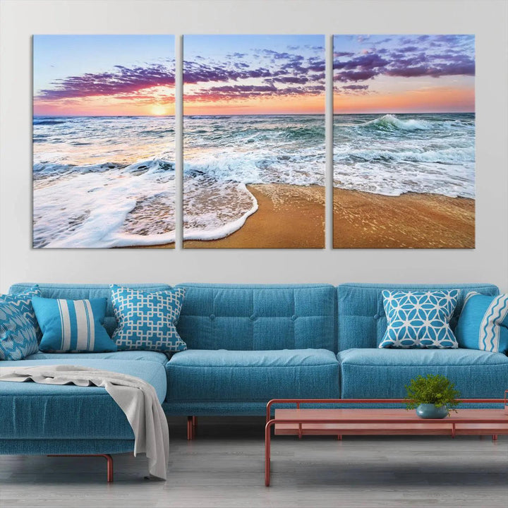 A triptych canvas wall art featuring the Tropical Beach Waves Art Print with a sunset ocean seascape adds striking beauty and perfectly complements the modern living room’s coastal decor.