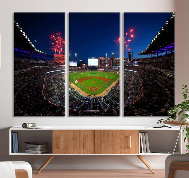 A nighttime scene of Truist Park with fireworks lighting up the sky comes to life in the Truist Park Atlanta Braves Baseball Stadium Wall Art Print, a large 3-panel canvas perfect for sports fans.