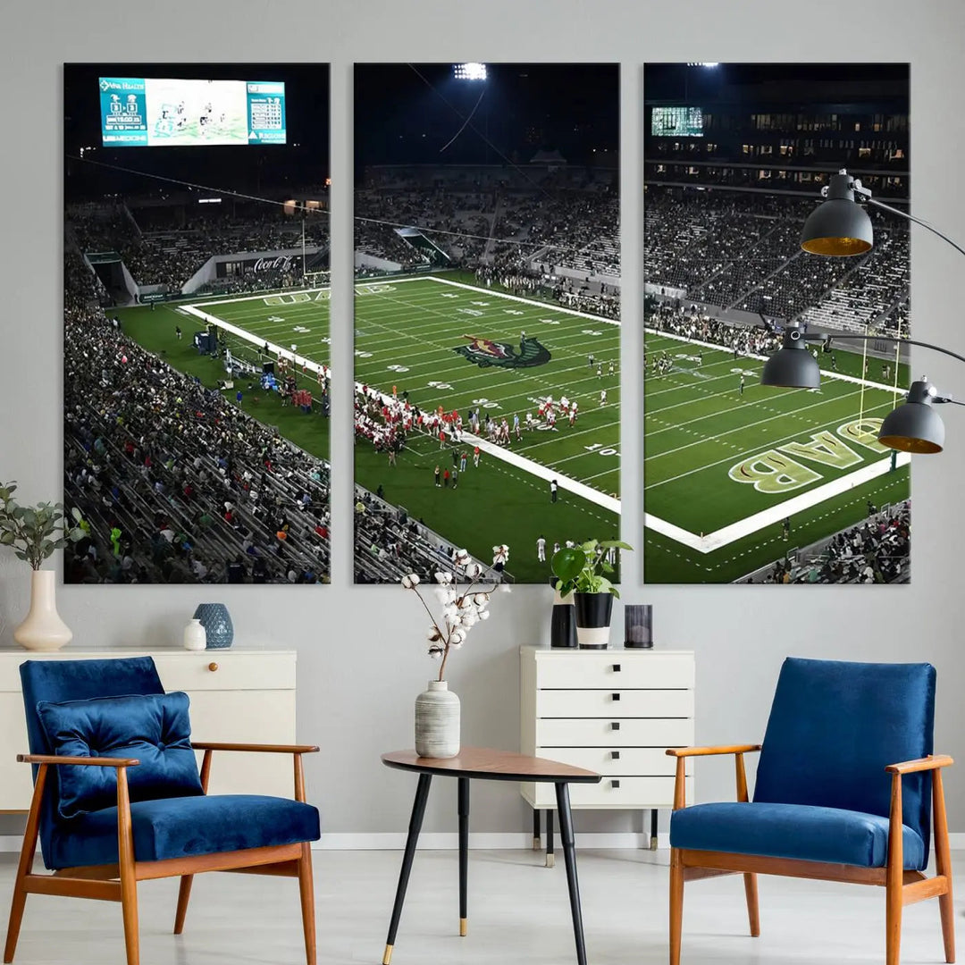 A dining area showcasing a gallery-quality triptych of the UAB Blazers Football Team Print at Birmingham Protective Stadium adorns the wall.