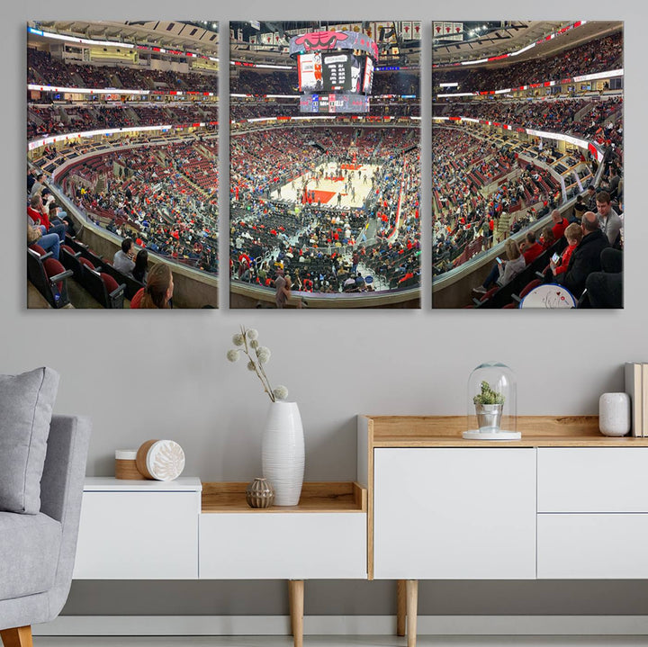 A panoramic view captures the bustling United Center during a Chicago Bulls game, showcasing the action on court and a prominent scoreboard overhead, ideal for immortalizing as a museum-quality canvas print.