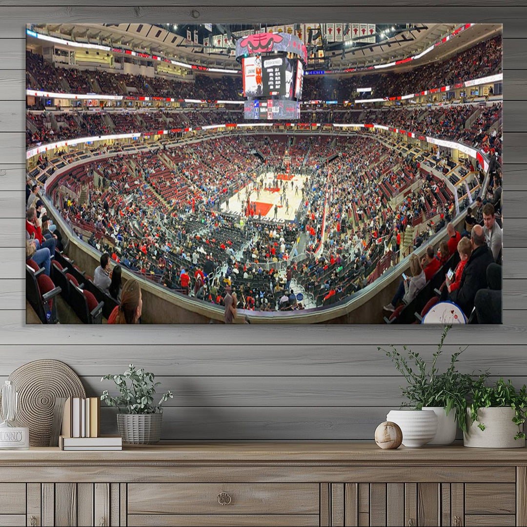 A panoramic view captures the bustling United Center during a Chicago Bulls game, showcasing the action on court and a prominent scoreboard overhead, ideal for immortalizing as a museum-quality canvas print.