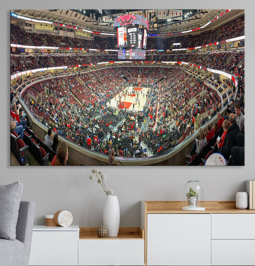 A panoramic view captures the bustling United Center during a Chicago Bulls game, showcasing the action on court and a prominent scoreboard overhead, ideal for immortalizing as a museum-quality canvas print.