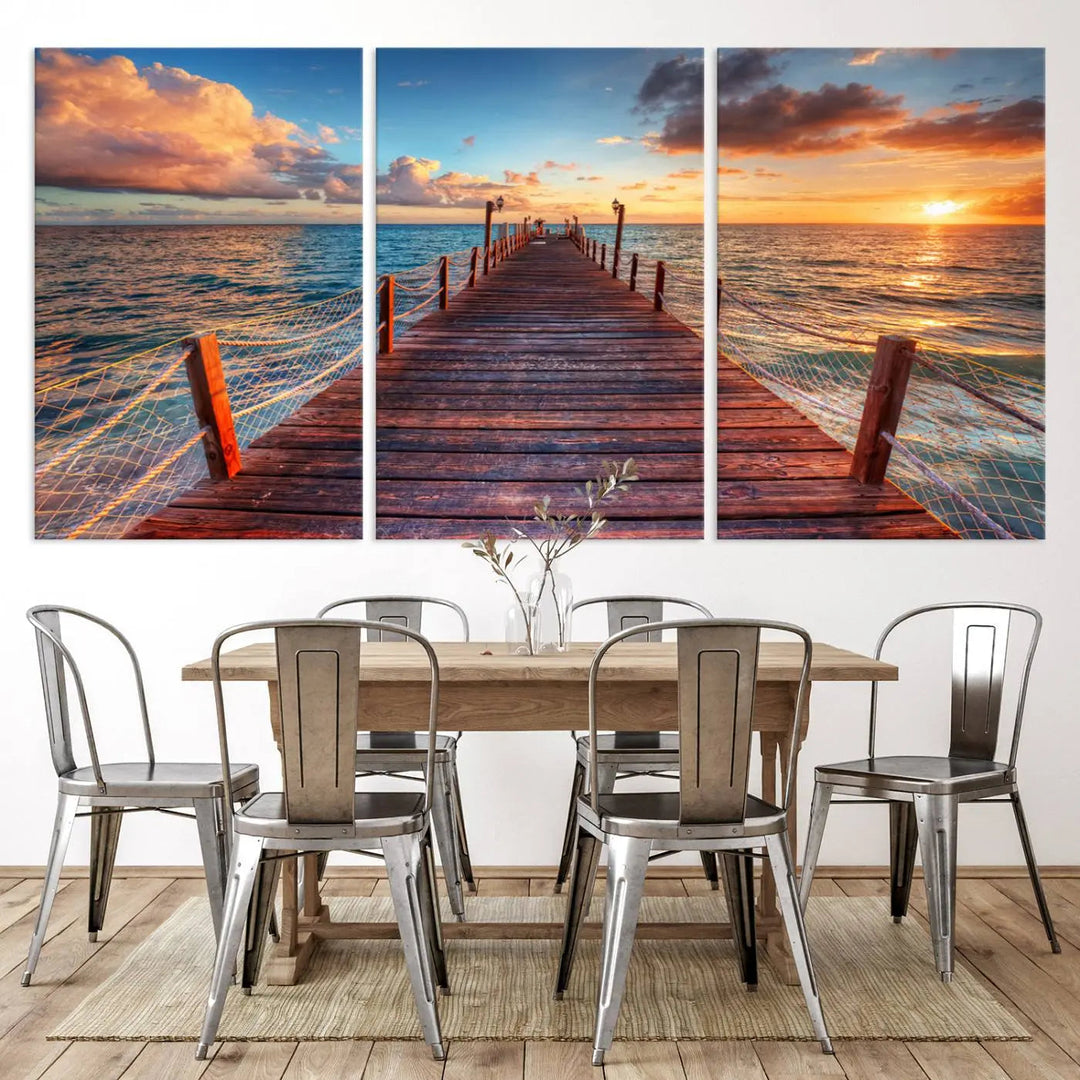 The breathtaking Vibrant Sunset Beach Wall Art Canvas Print – Tropical Coastal Ocean Decor for Modern and Rustic Spaces captures a triptych of a pier extending into the ocean at sunset, perfect for enhancing your home decor.