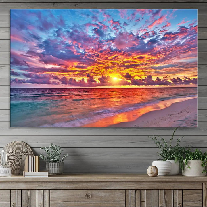 The living room showcases vibrant tropical sunset beach wall art canvas prints, highlighting a captivating coastal ocean waves scene.