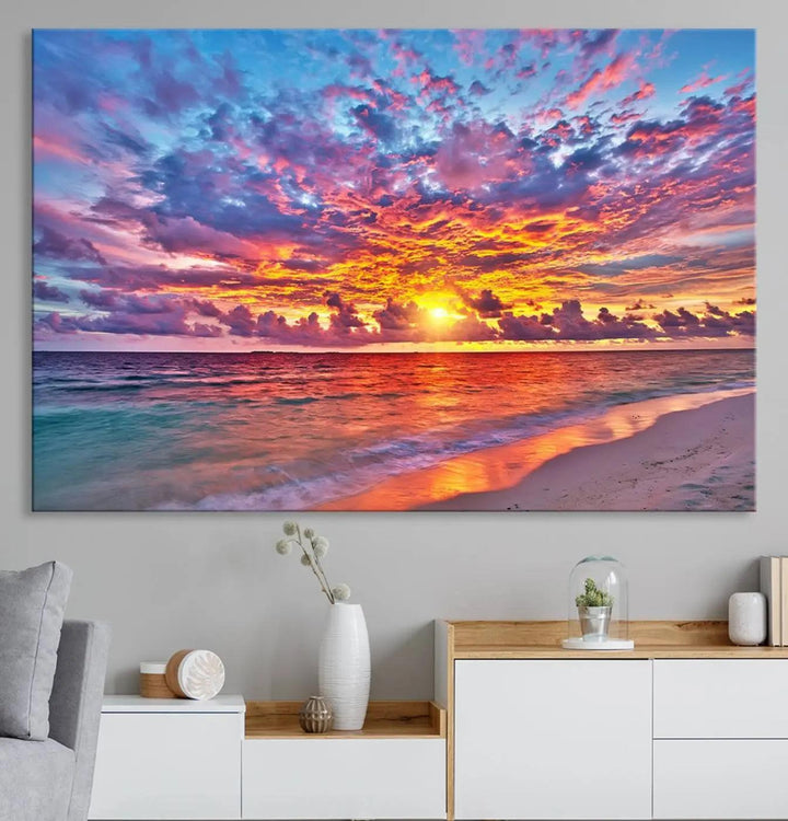 The living room showcases vibrant tropical sunset beach wall art canvas prints, highlighting a captivating coastal ocean waves scene.