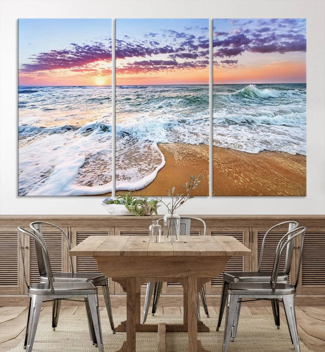 The "Vivid Sunset Ocean Waves Wall Art" hangs on the wall, capturing the serene beauty of the sea. This coastal beach canvas print triptych perfectly enhances living rooms and relaxation spaces.