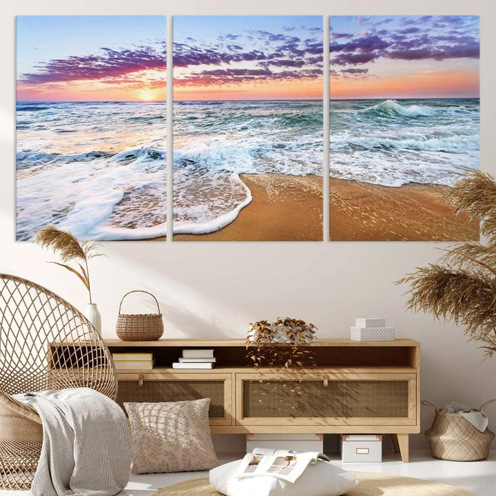 The "Vivid Sunset Ocean Waves Wall Art" hangs on the wall, capturing the serene beauty of the sea. This coastal beach canvas print triptych perfectly enhances living rooms and relaxation spaces.