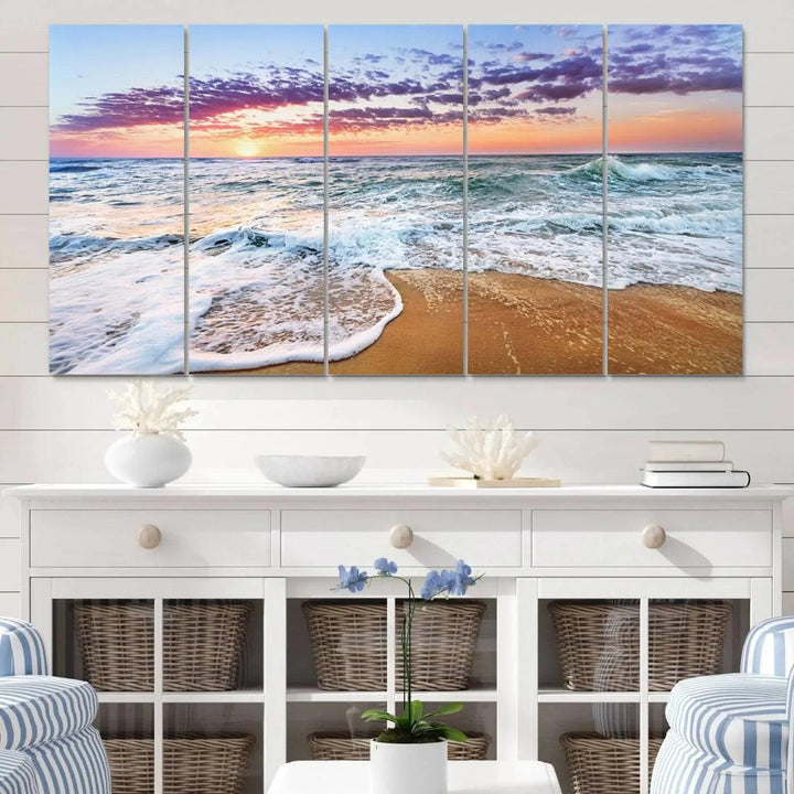 The "Vivid Sunset Ocean Waves Wall Art" hangs on the wall, capturing the serene beauty of the sea. This coastal beach canvas print triptych perfectly enhances living rooms and relaxation spaces.