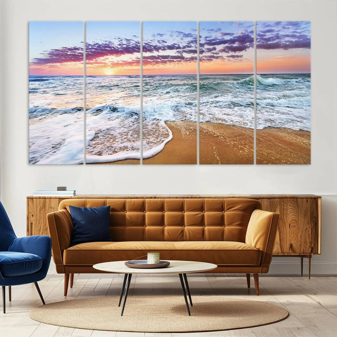 The "Vivid Sunset Ocean Waves Wall Art" hangs on the wall, capturing the serene beauty of the sea. This coastal beach canvas print triptych perfectly enhances living rooms and relaxation spaces.