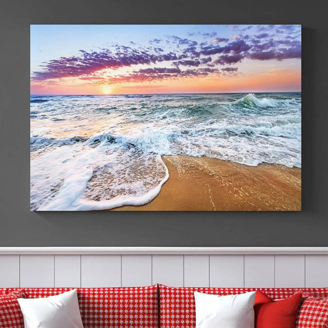 The "Vivid Sunset Ocean Waves Wall Art" hangs on the wall, capturing the serene beauty of the sea. This coastal beach canvas print triptych perfectly enhances living rooms and relaxation spaces.