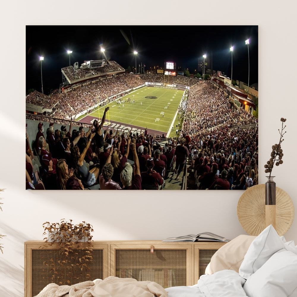 The Washington-Grizzly Stadium Canvas Print features a vibrant depiction of a packed football stadium at night. This American Football Wall Art is crafted on gallery-wrapped canvases with a UV-protective coating to maintain its lasting vibrancy.