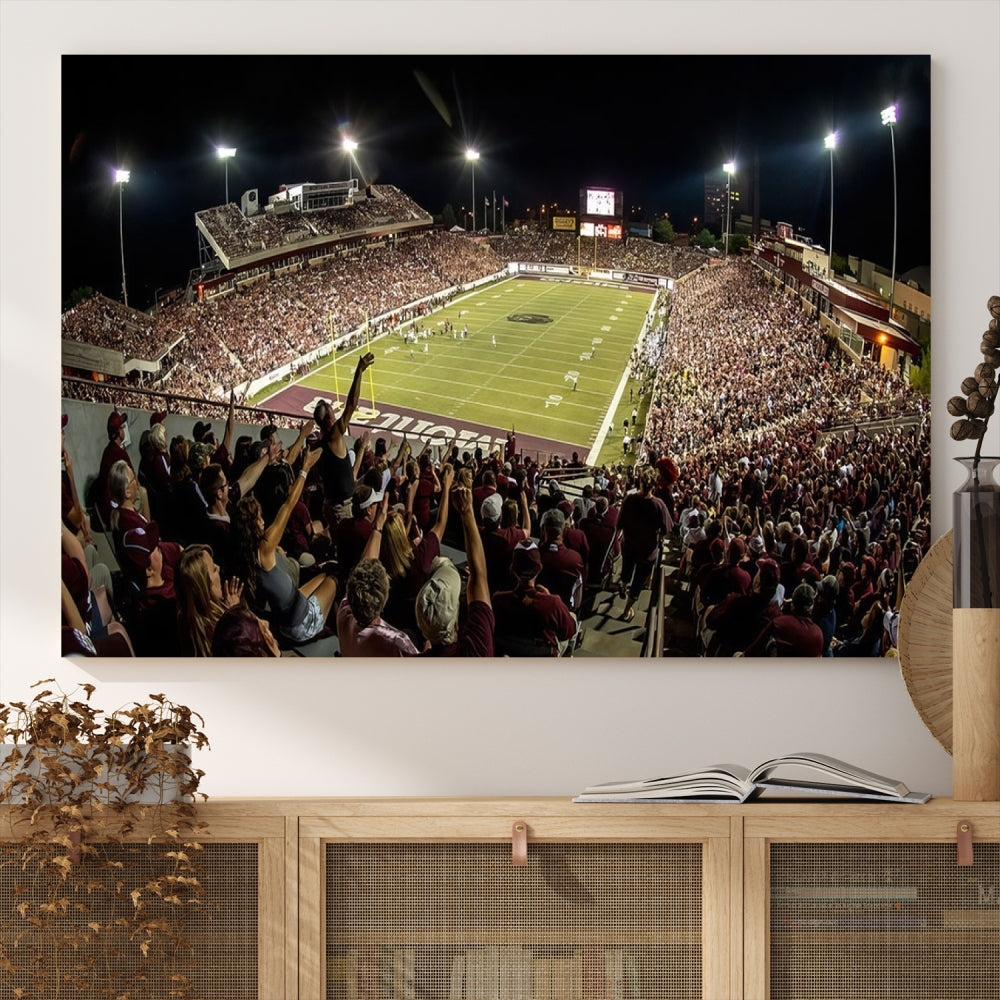 The Washington-Grizzly Stadium Canvas Print features a vibrant depiction of a packed football stadium at night. This American Football Wall Art is crafted on gallery-wrapped canvases with a UV-protective coating to maintain its lasting vibrancy.