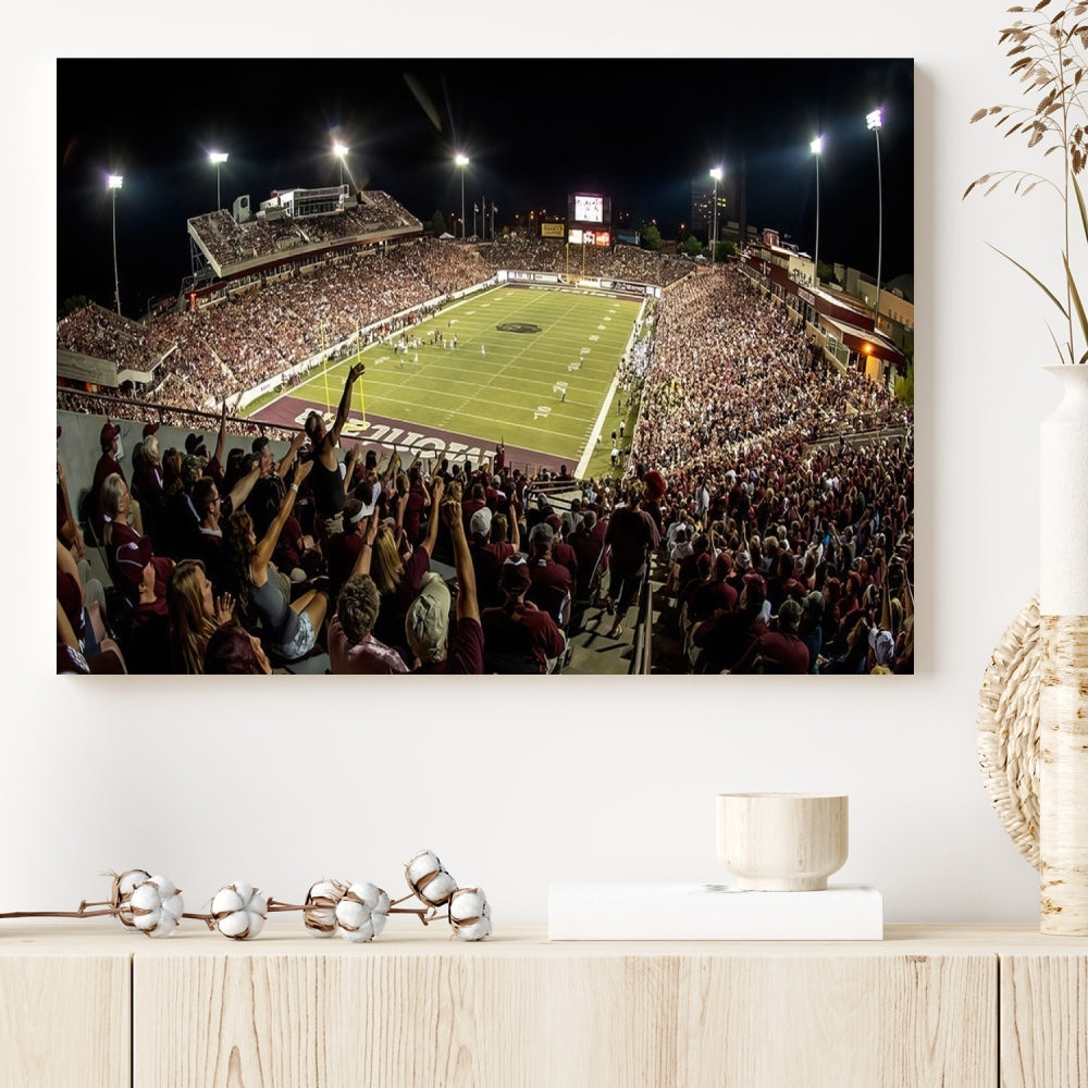 The Washington-Grizzly Stadium Canvas Print features a vibrant depiction of a packed football stadium at night. This American Football Wall Art is crafted on gallery-wrapped canvases with a UV-protective coating to maintain its lasting vibrancy.