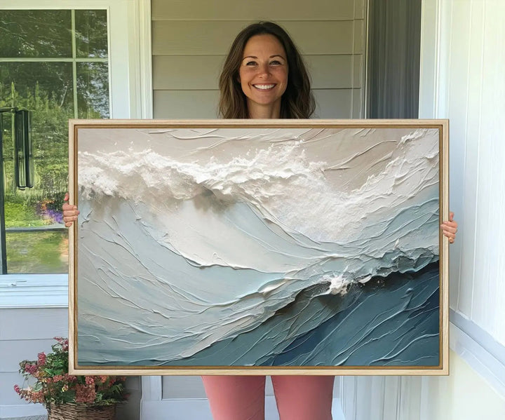 The Waves Abstract Wall Art Print is a large textured painting featuring ocean waves in beige and blue tones. This modern framed abstract canvas print captures the serene essence of seaside tranquility and serves as stunning ready-to-hang wall art, making it perfect as living room decor.