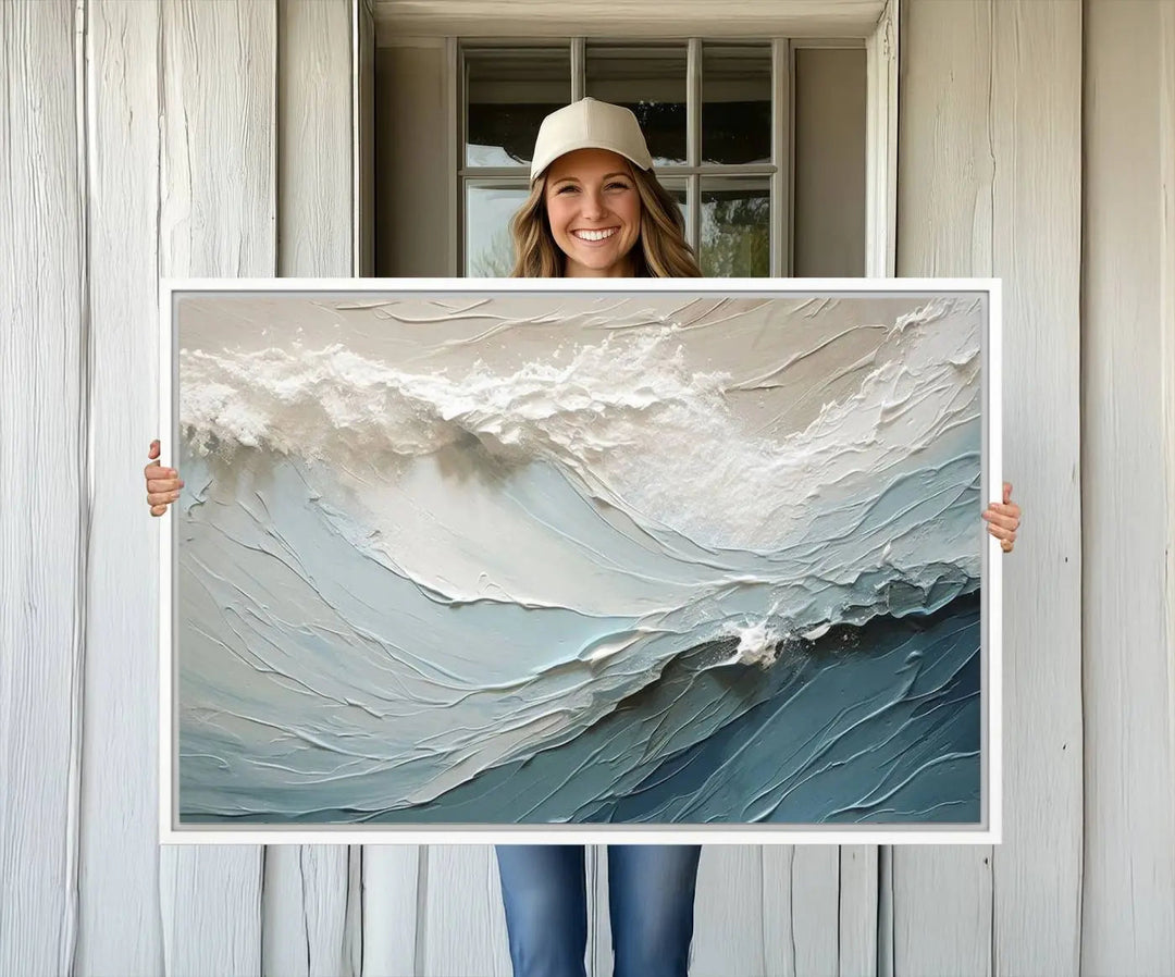 The Waves Abstract Wall Art Print is a large textured painting featuring ocean waves in beige and blue tones. This modern framed abstract canvas print captures the serene essence of seaside tranquility and serves as stunning ready-to-hang wall art, making it perfect as living room decor.