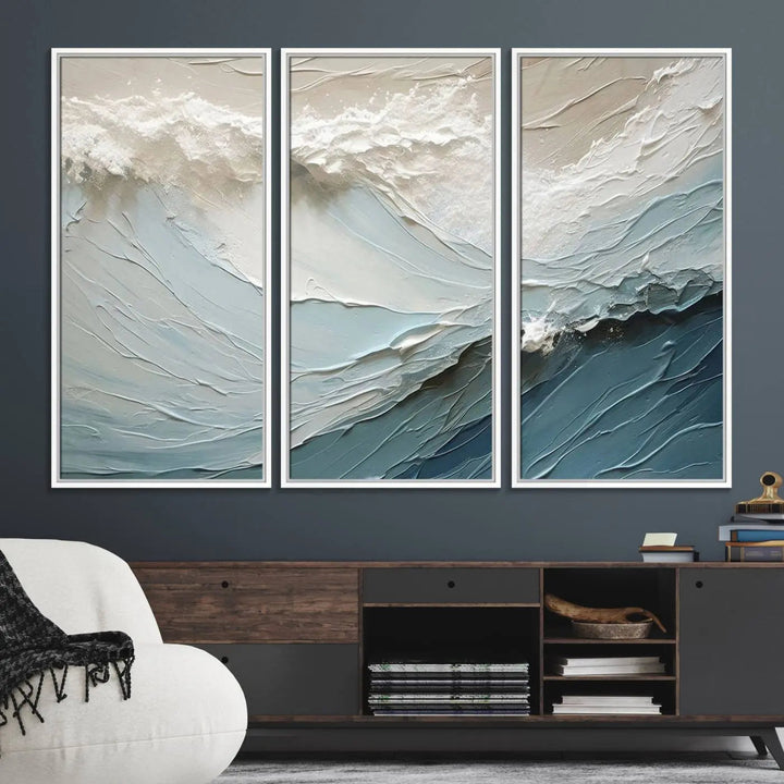 The Waves Abstract Wall Art Print is a large textured painting featuring ocean waves in beige and blue tones. This modern framed abstract canvas print captures the serene essence of seaside tranquility and serves as stunning ready-to-hang wall art, making it perfect as living room decor.