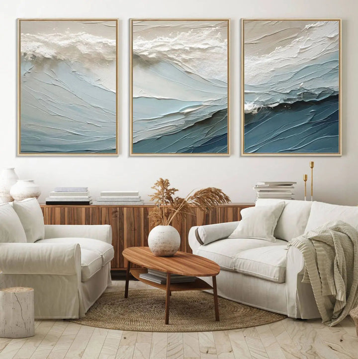 The Waves Abstract Wall Art Print is a large textured painting featuring ocean waves in beige and blue tones. This modern framed abstract canvas print captures the serene essence of seaside tranquility and serves as stunning ready-to-hang wall art, making it perfect as living room decor.