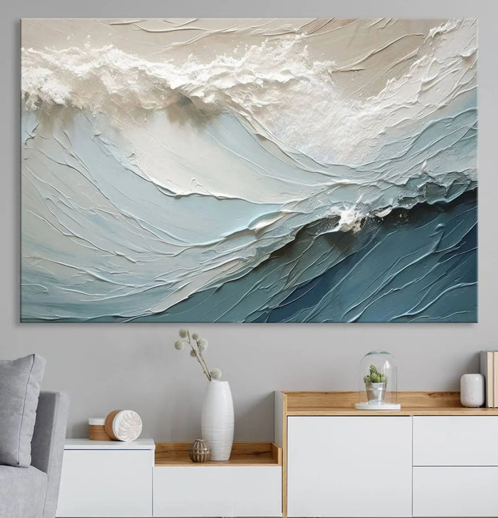 The Waves Abstract Wall Art Print, a captivating piece of modern framed abstract canvas, beautifully decorates the wall. This abstract painting is designed to enhance your living room decor and offers the convenience of being ready to hang.