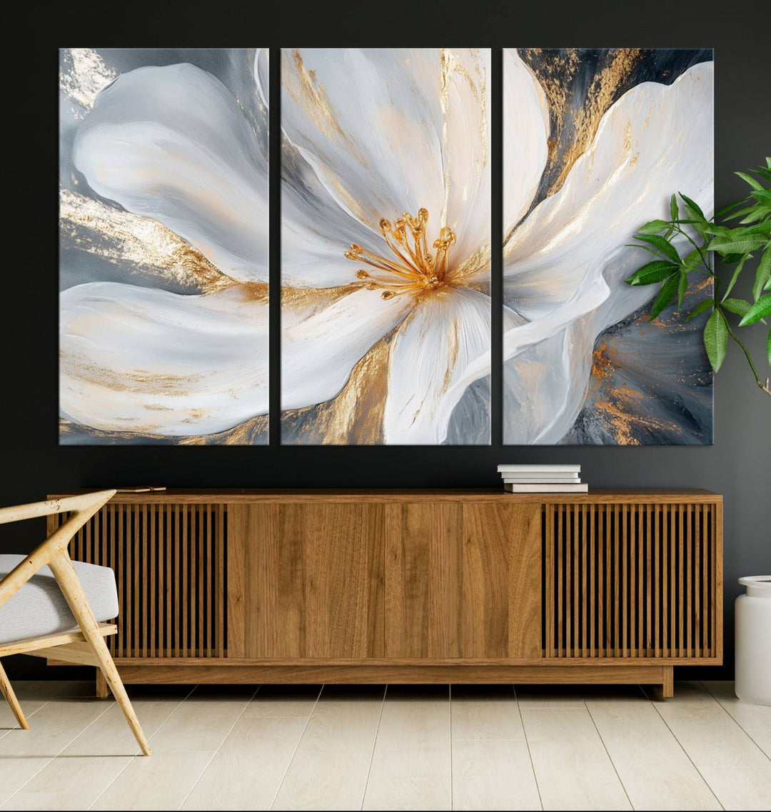 A triptych of "White and Gold Floral Canvas Wall Art - Framed and Ready to Hang" adorns the wall, creating an elegant modern living room display.