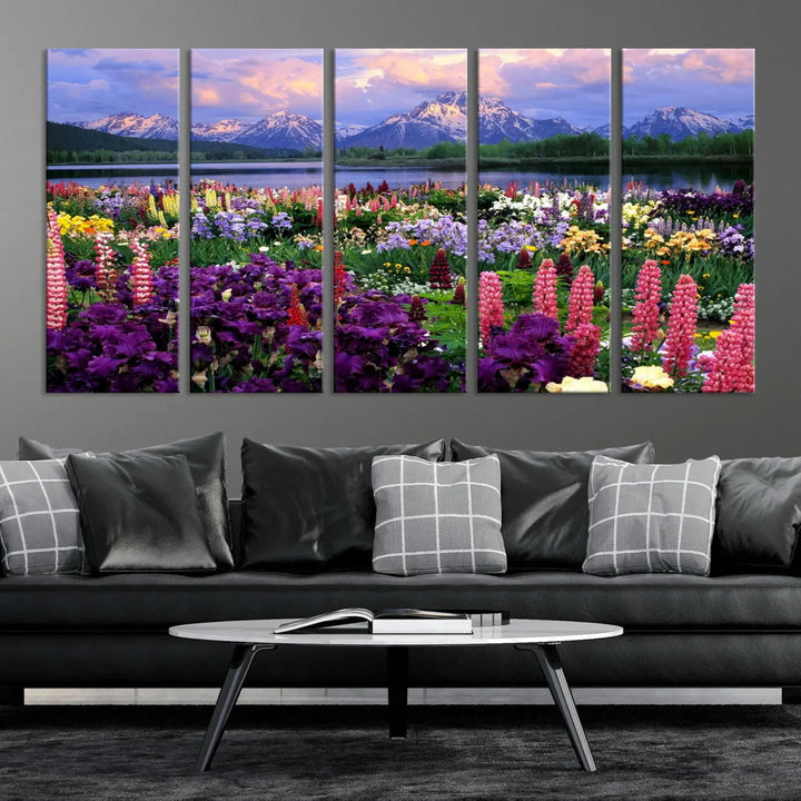 The wildflower canvas print, featuring blooming meadows and mountains, stylishly accents a modern living room.