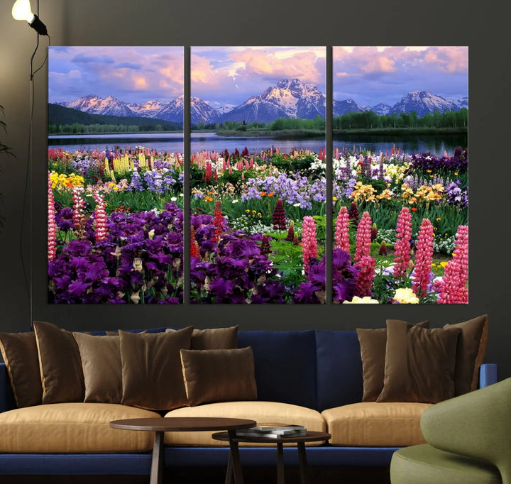 The wildflower canvas print, featuring blooming meadows and mountains, stylishly accents a modern living room.