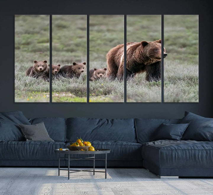 The canvas wall art print, titled "Queen of the Tetons," features a photo of 399 grizzly bear cubs walking with a larger bear in a green, open field. This striking piece is framed and leaning against a wall, showcasing its gallery-quality finish.