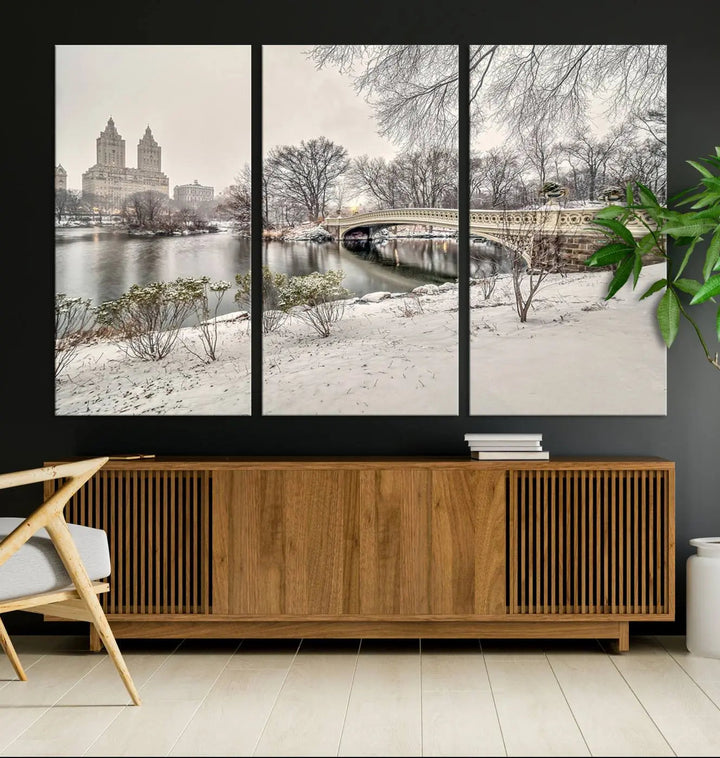 The dining room's winter scene is enhanced by the "Winter Park Wall Art" showcasing The Bow Bridge in Central Park, New York City as a premium canvas print, handcrafted in the USA.