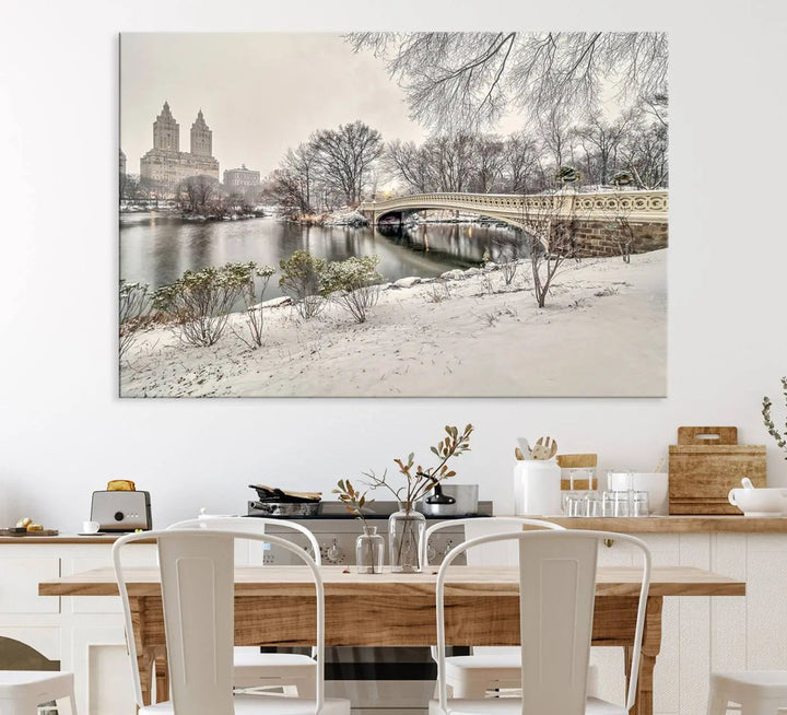 The dining room's winter scene is enhanced by the "Winter Park Wall Art" showcasing The Bow Bridge in Central Park, New York City as a premium canvas print, handcrafted in the USA.