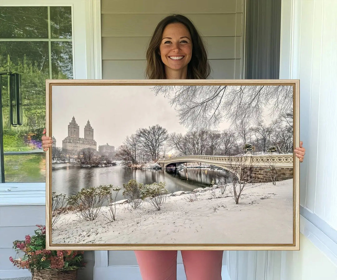 The dining room's winter scene is enhanced by the "Winter Park Wall Art" showcasing The Bow Bridge in Central Park, New York City as a premium canvas print, handcrafted in the USA.