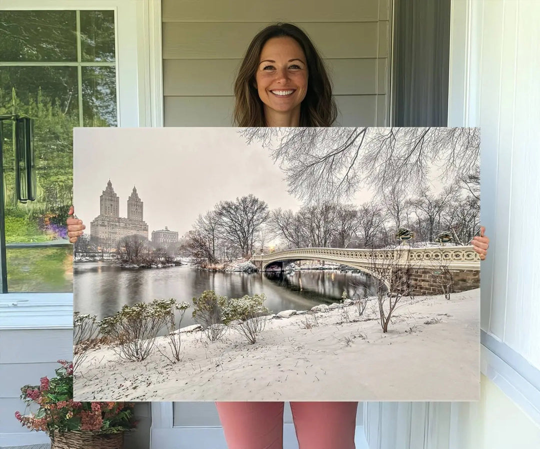 The dining room's winter scene is enhanced by the "Winter Park Wall Art" showcasing The Bow Bridge in Central Park, New York City as a premium canvas print, handcrafted in the USA.