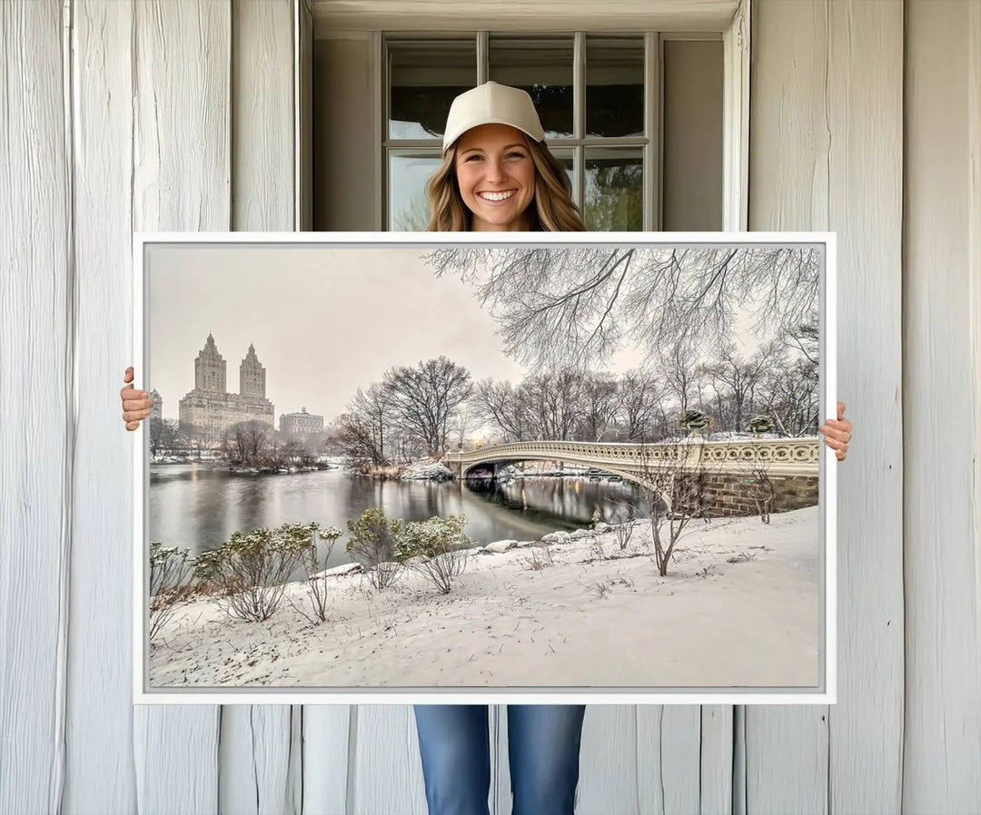 The dining room's winter scene is enhanced by the "Winter Park Wall Art" showcasing The Bow Bridge in Central Park, New York City as a premium canvas print, handcrafted in the USA.