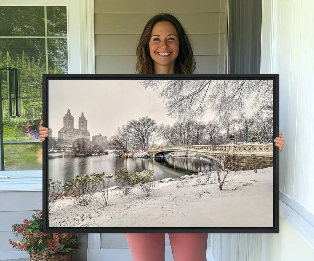 The dining room's winter scene is enhanced by the "Winter Park Wall Art" showcasing The Bow Bridge in Central Park, New York City as a premium canvas print, handcrafted in the USA.