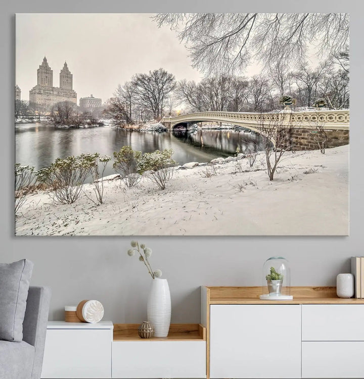 The dining room's winter scene is enhanced by the "Winter Park Wall Art" showcasing The Bow Bridge in Central Park, New York City as a premium canvas print, handcrafted in the USA.