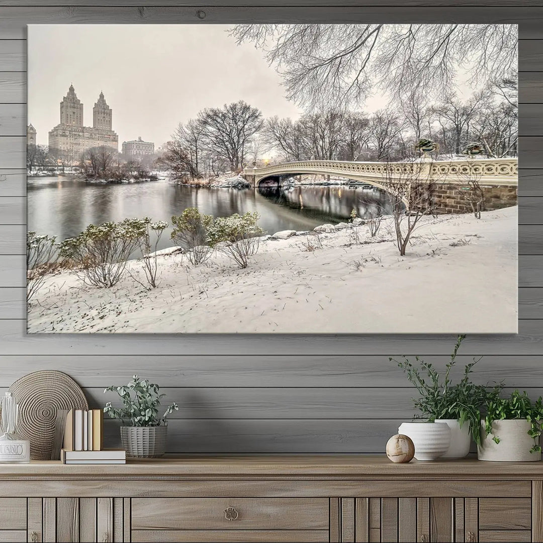 The dining room's winter scene is enhanced by the "Winter Park Wall Art" showcasing The Bow Bridge in Central Park, New York City as a premium canvas print, handcrafted in the USA.