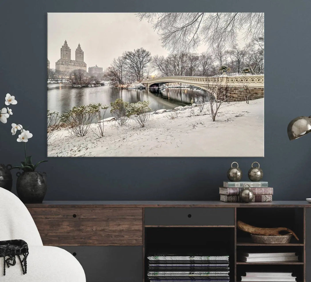 The dining room's winter scene is enhanced by the "Winter Park Wall Art" showcasing The Bow Bridge in Central Park, New York City as a premium canvas print, handcrafted in the USA.